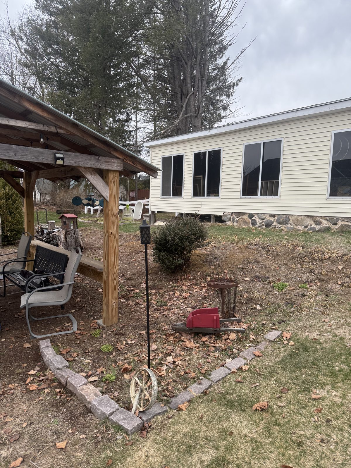 Backyard with pavilion and paver-edged garden bed